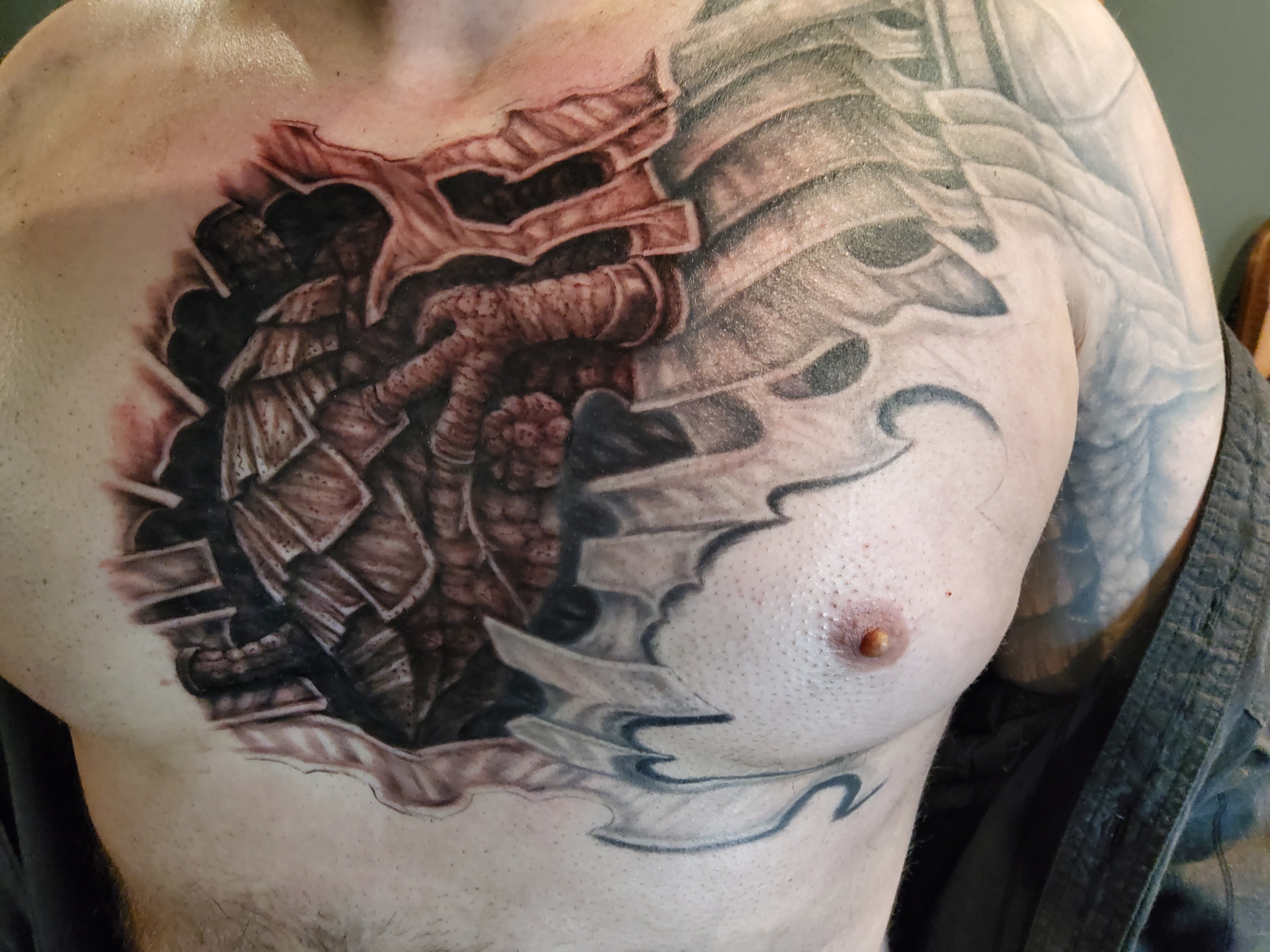 Dragon chest tattoo in a dark fantasy style