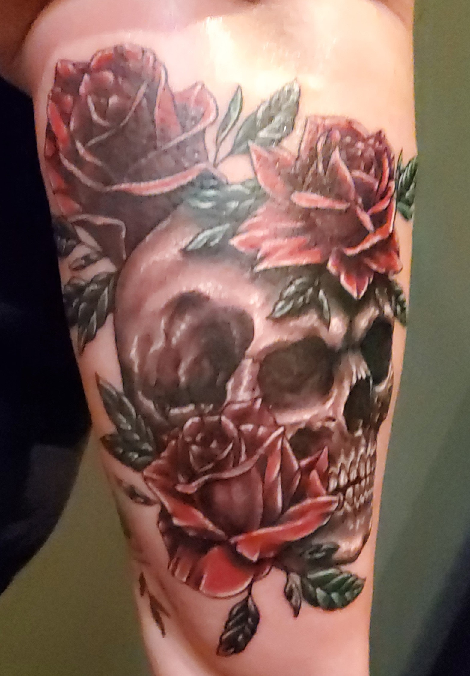 Custom floral tattoo sleeve with roses, leaves, and shaded botanical details