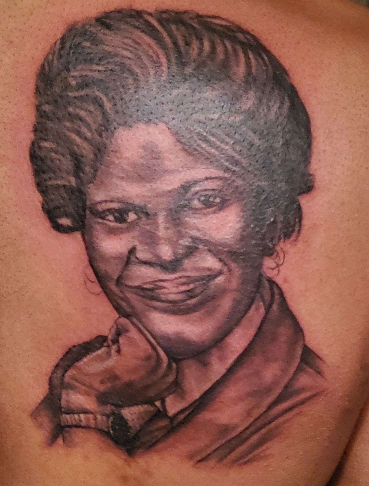Black and gray portrait tattoo on a back